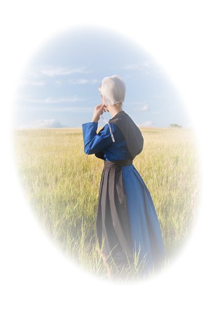 Amish woman looking into a field