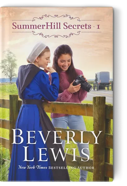 Two teenagers standing with a fence between them looking at phone
